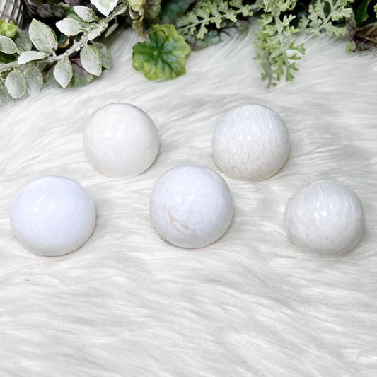 a group of 5 scolecite crystal spheres